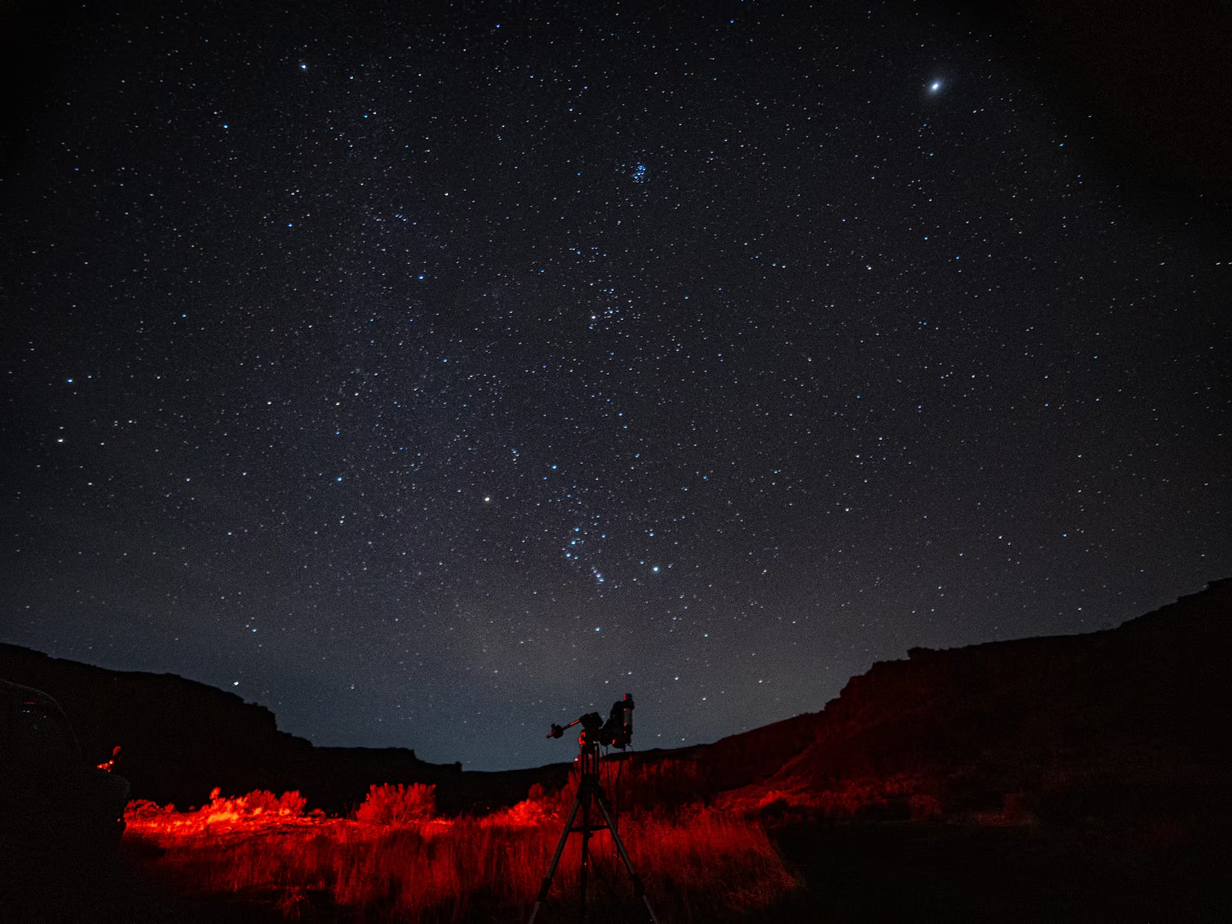 Image of a telescope in front of the night sky