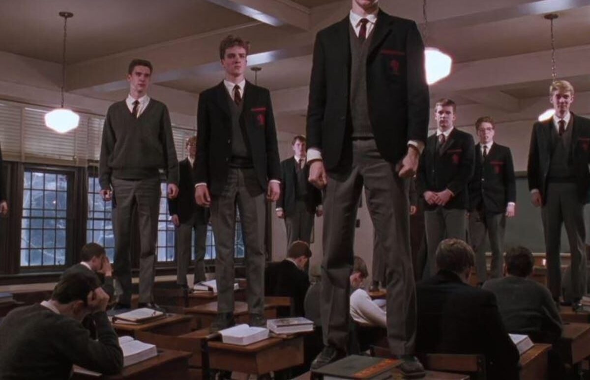 prep school boys standing on their desks reciting poems in the Robin Williams movie Dead Poets' Society